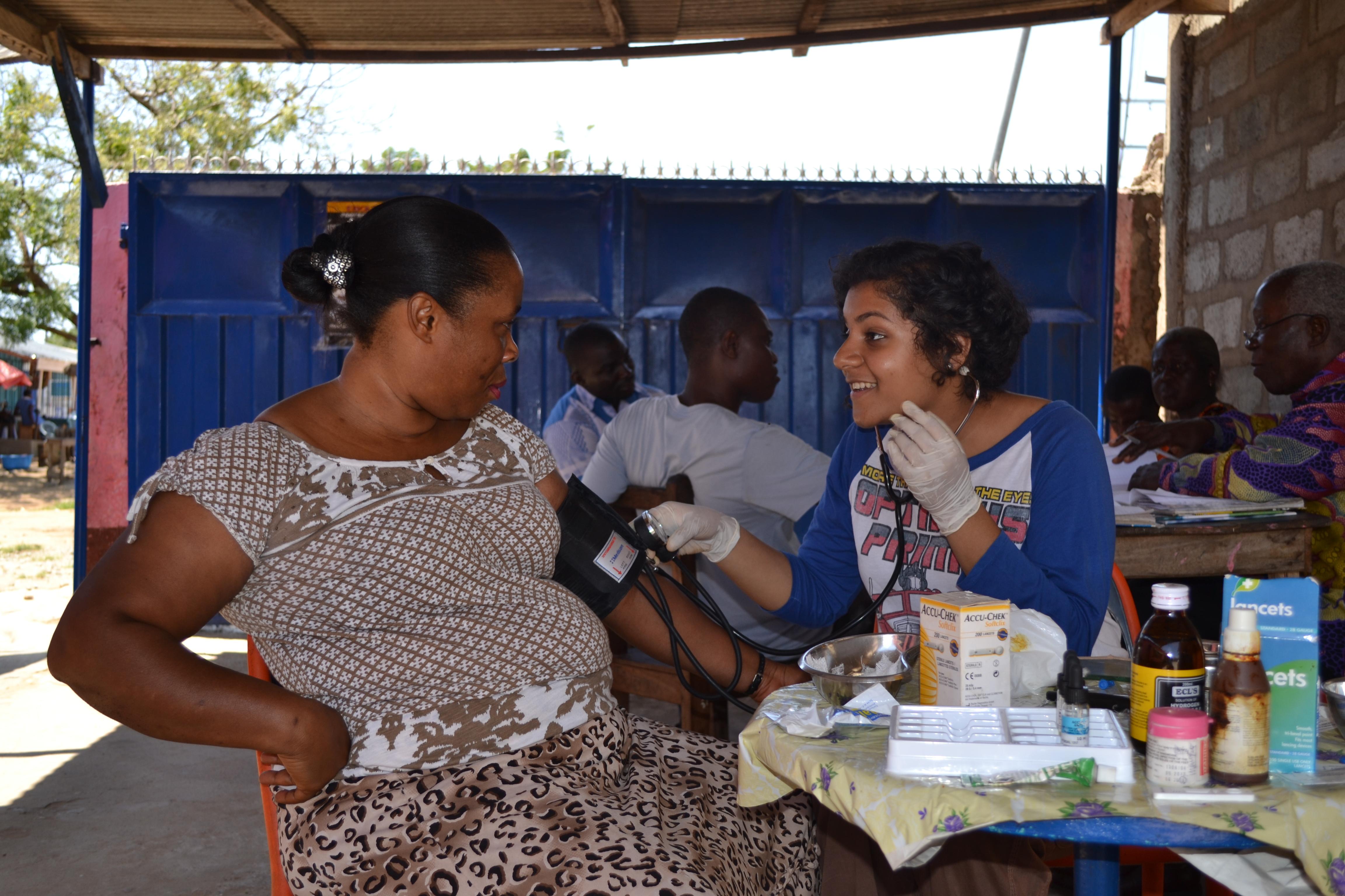 Projects Abroad intern performing a check up on a local woman as part of her midwifery internship in Ghana. A female Projects Abroad intern is pictured performing a check up on a local woman as part of her midwifery internship in Ghana.